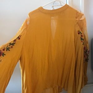 Loose mustard blouse with pretty arm details!